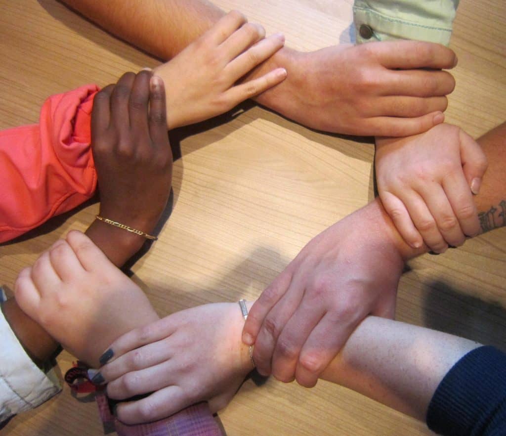 Porn addiction recovery group members holding hands. Choosing the right Christian accountability partner for porn recovery is essential for the journey to recovery journey